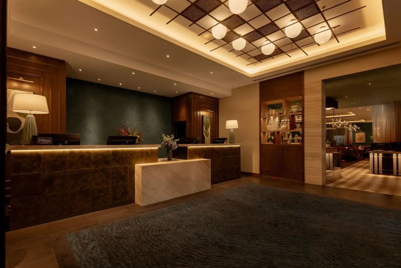 a lobby with a reception desk and a salon at DoubleTree by Hilton London Victoria in London